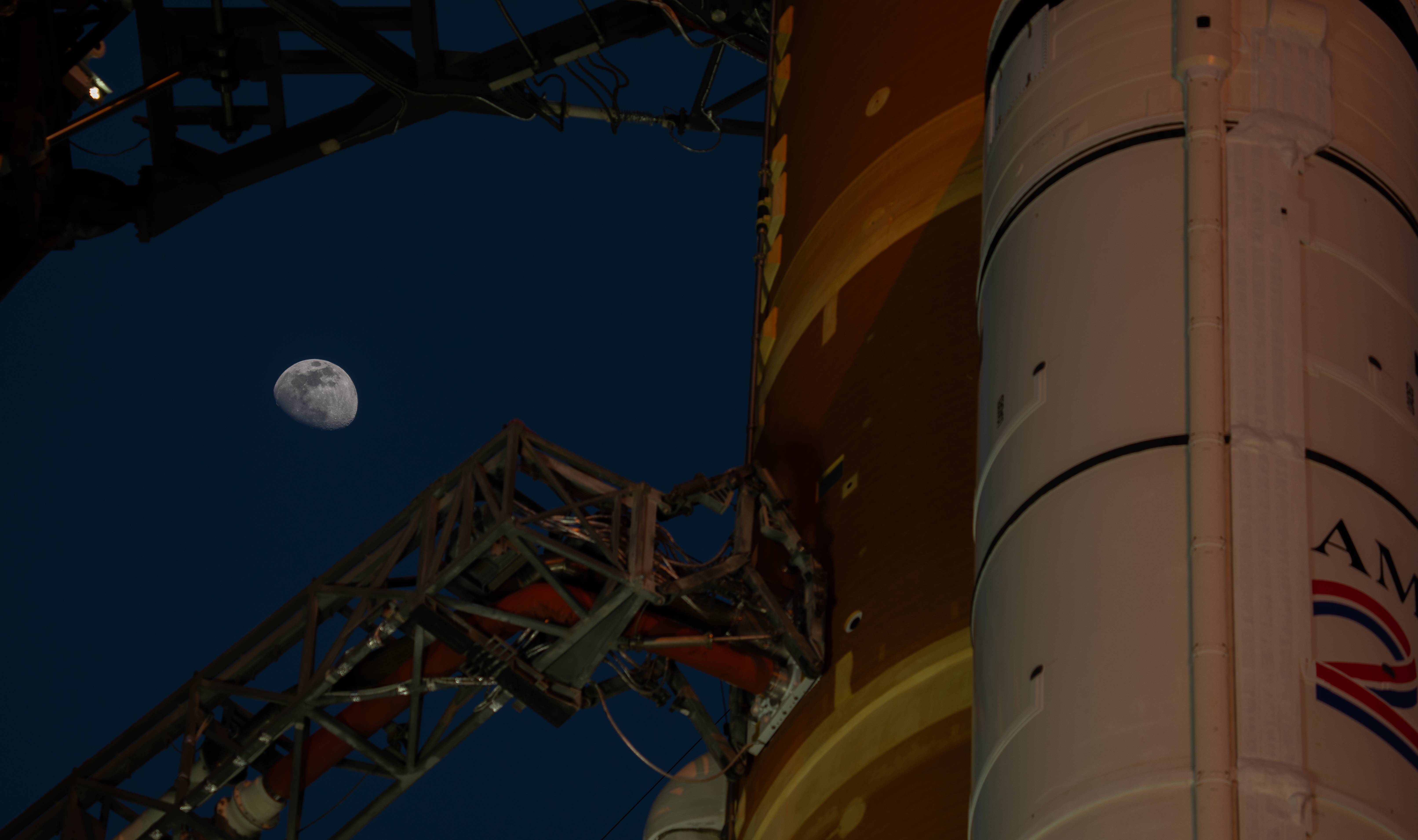 Moon Seen Shining on Full Artemis II Stack at Launch Pad 39B